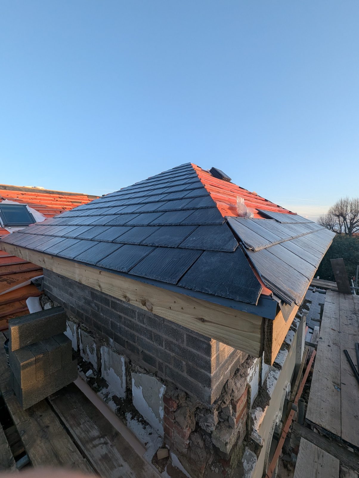 New slate coverings being laid on the tower roof